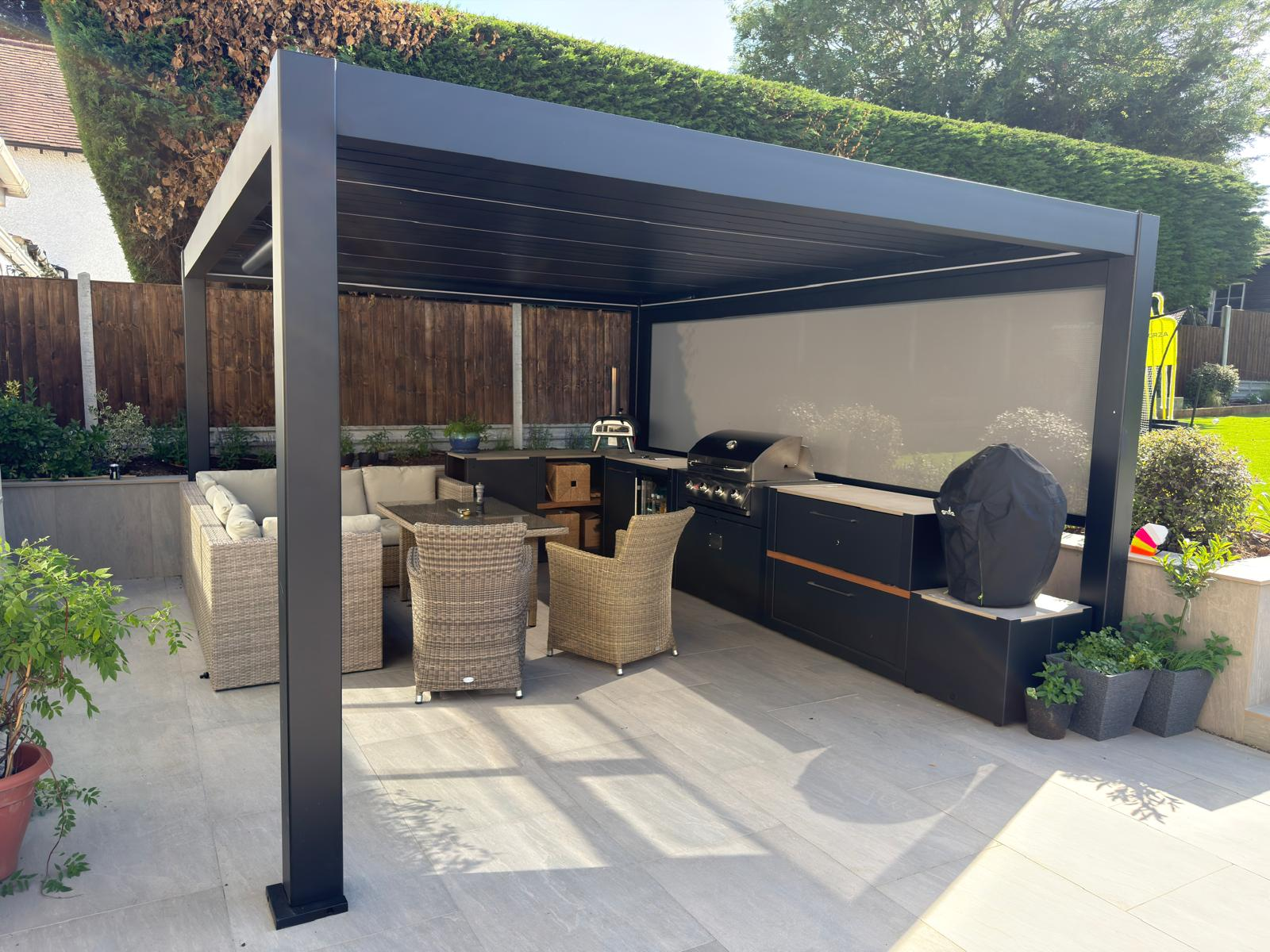 SOLA pergola with outdoor kitchen and dining area